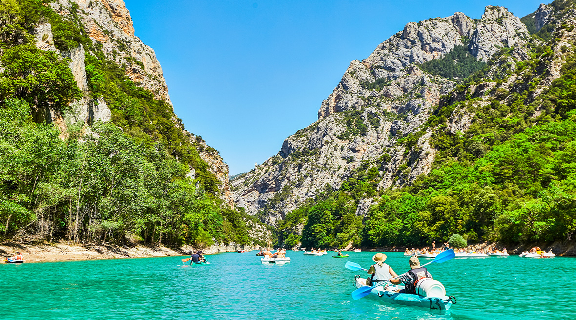 People kayaking through the Gorges du Verdon on clear blue waters